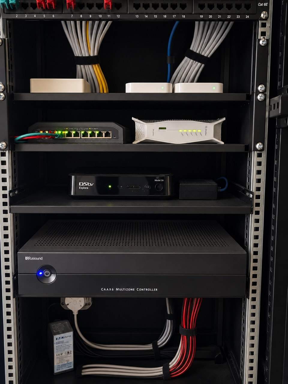 Open smart-home equipment rack with structured cabling and labelled network hardware